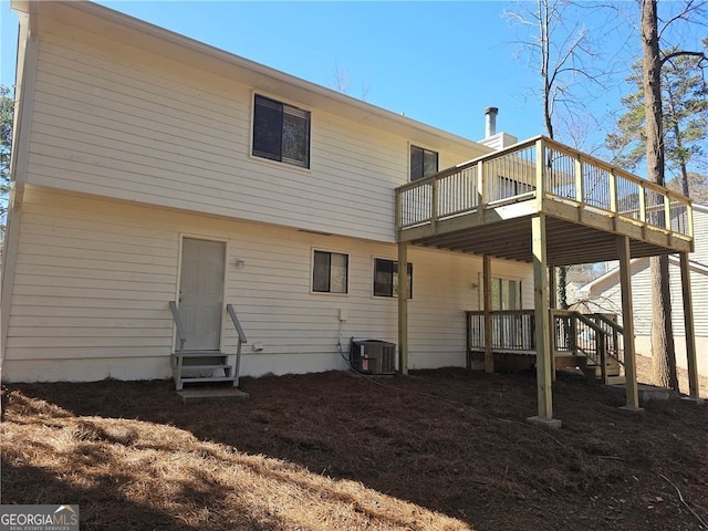 back of house with entry steps, cooling unit, and a wooden deck