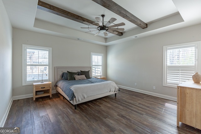 bedroom with baseboards, a raised ceiling, and dark wood-type flooring