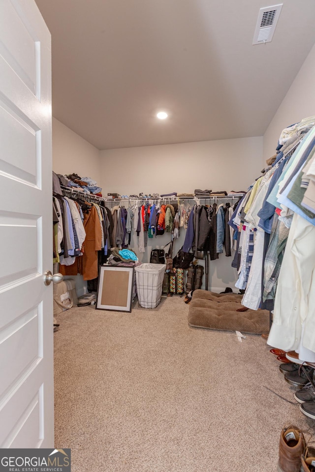 walk in closet with visible vents and carpet flooring