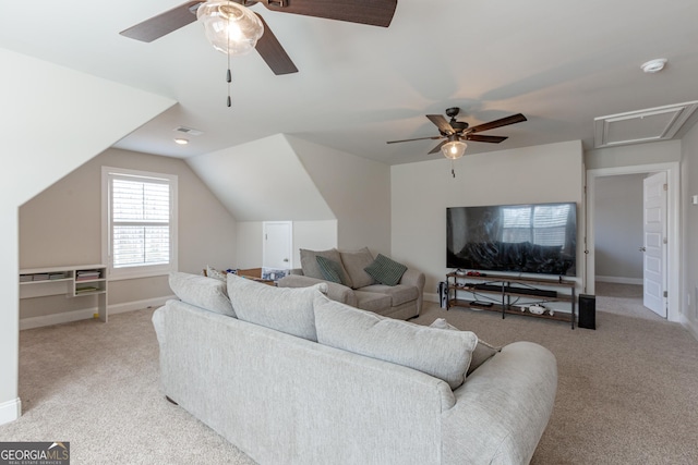 carpeted living room with lofted ceiling, baseboards, visible vents, and a ceiling fan