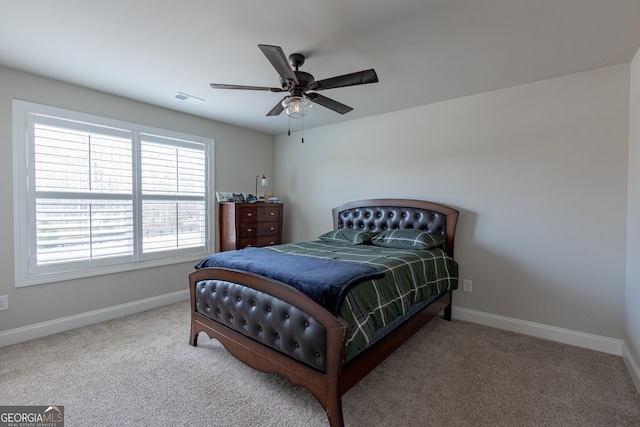 bedroom featuring carpet floors, a ceiling fan, visible vents, and baseboards