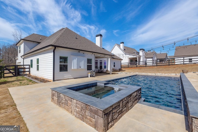 view of pool featuring a fenced backyard, a fenced in pool, a patio, and an in ground hot tub