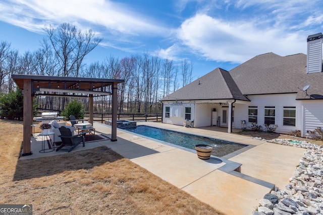 view of swimming pool with a pool with connected hot tub, fence, a patio, and area for grilling