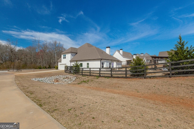 view of property exterior featuring fence