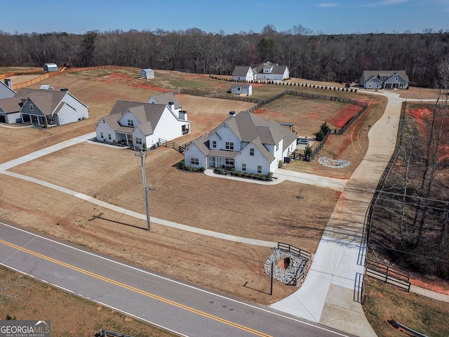 bird's eye view with a wooded view