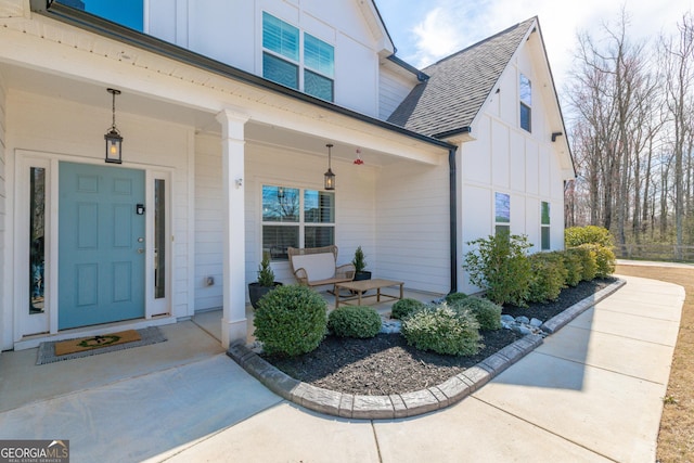 property entrance featuring a porch, board and batten siding, and a shingled roof