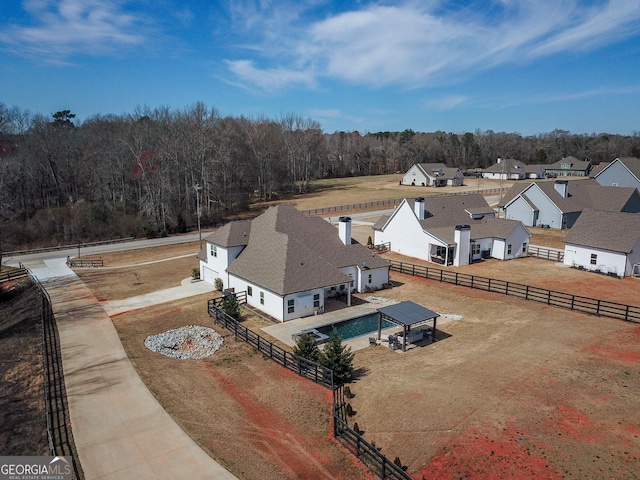 drone / aerial view featuring a wooded view