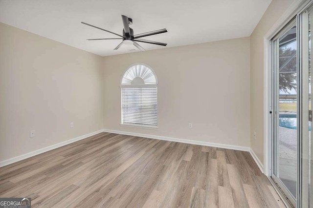 unfurnished room featuring a ceiling fan, light wood-type flooring, and baseboards