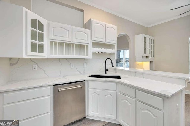 kitchen featuring ornamental molding, a sink, decorative backsplash, and stainless steel dishwasher