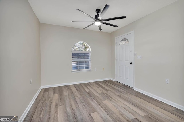 unfurnished room with a ceiling fan, baseboards, and wood finished floors