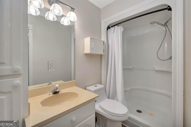 full bathroom featuring toilet, a stall shower, and vanity