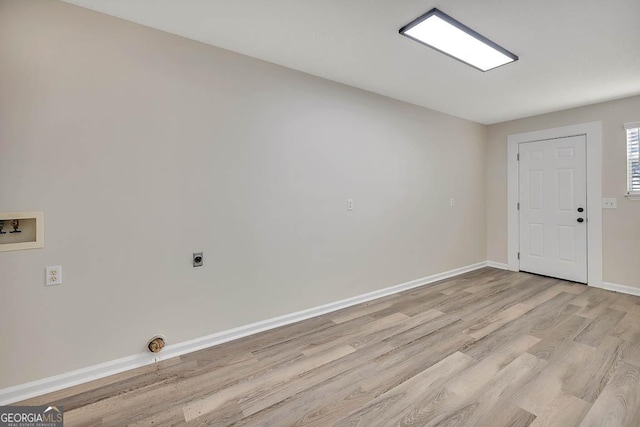 interior space featuring hookup for a washing machine, laundry area, baseboards, light wood finished floors, and electric dryer hookup