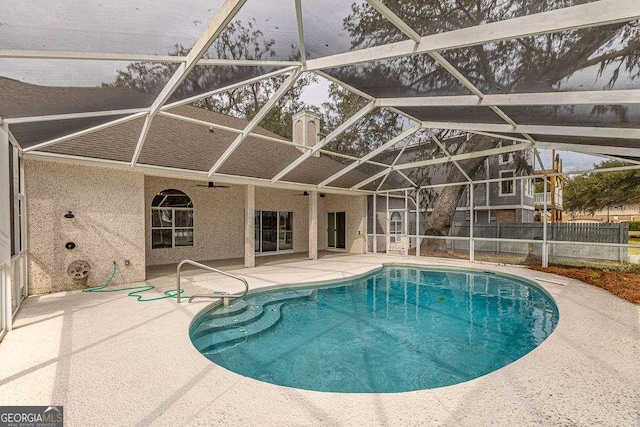 view of pool featuring a fenced in pool, ceiling fan, a lanai, fence, and a patio area