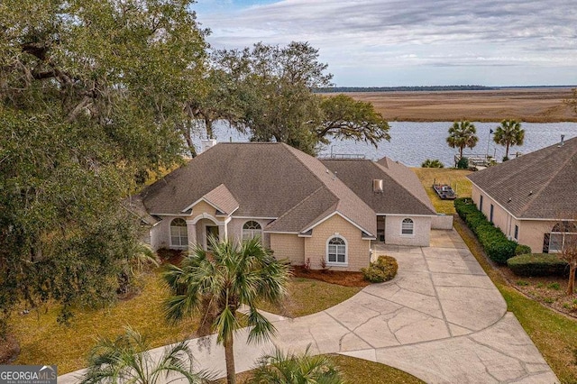 birds eye view of property with a water view