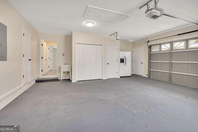 garage with a sink and a garage door opener