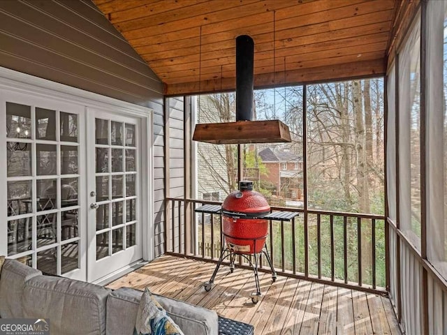 sunroom / solarium with lofted ceiling, wood ceiling, and french doors