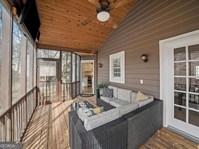 sunroom with lofted ceiling, wood ceiling, and a ceiling fan