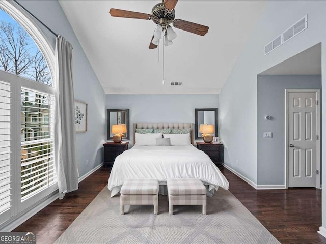 bedroom with high vaulted ceiling, visible vents, baseboards, and wood finished floors