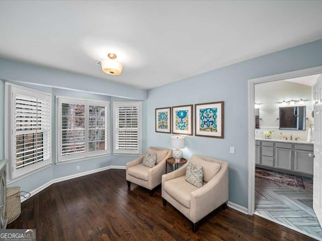 living area featuring baseboards and wood finished floors