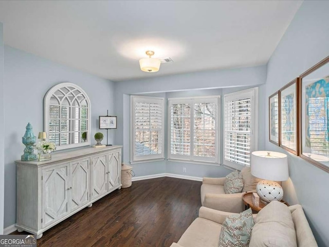 living area featuring dark wood-style floors and baseboards