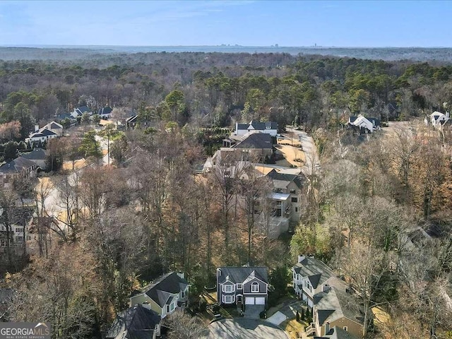 bird's eye view with a wooded view