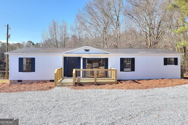 view of front of property with crawl space, metal roof, and a wooden deck