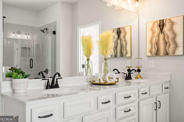 full bath featuring double vanity, a shower stall, and a sink