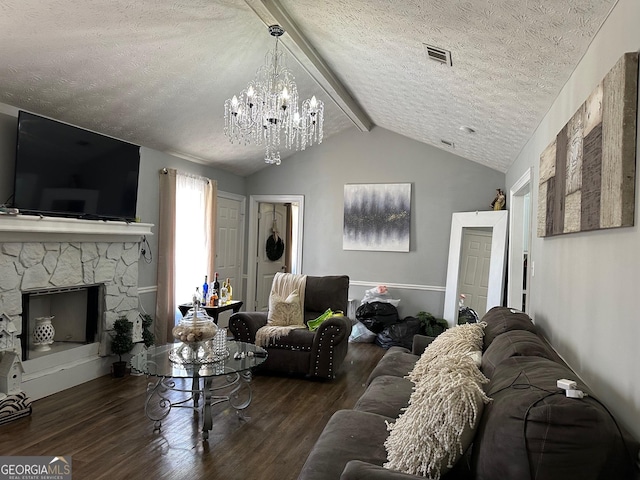 living room with lofted ceiling with beams, a textured ceiling, a fireplace, and wood finished floors