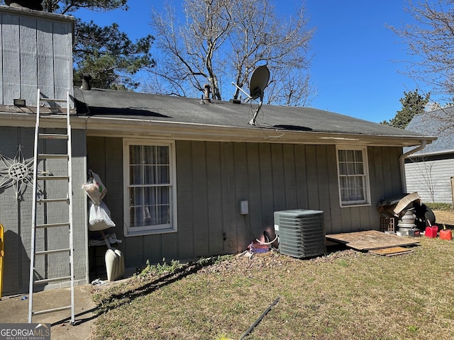 view of property exterior with a yard and central air condition unit