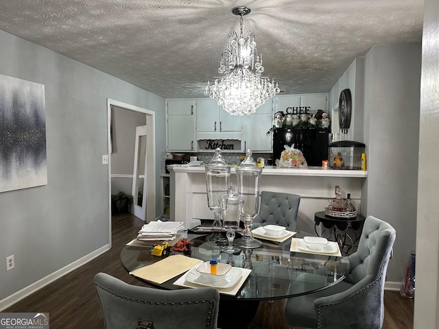 dining room featuring a textured ceiling, an inviting chandelier, dark wood finished floors, and baseboards