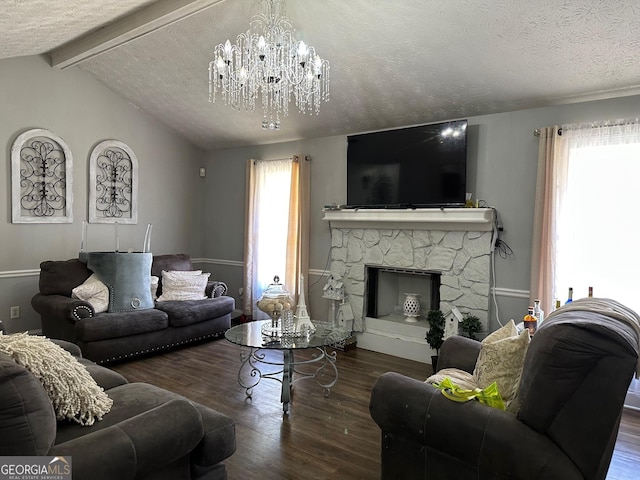 living area with vaulted ceiling with beams, an inviting chandelier, a stone fireplace, a textured ceiling, and wood finished floors