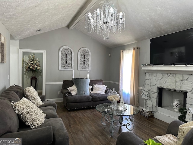 living room with lofted ceiling with beams, a textured ceiling, wood finished floors, and a stone fireplace