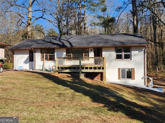 view of front of property with a deck, a front lawn, and brick siding