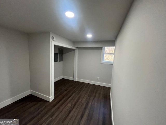 basement featuring recessed lighting, baseboards, and dark wood-style flooring