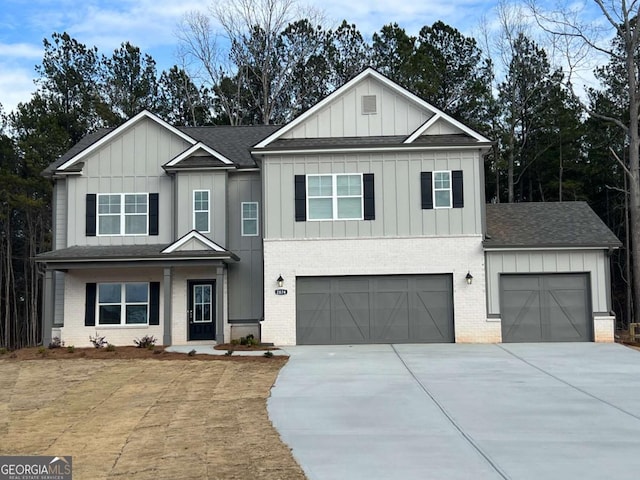 view of front of house featuring a garage, concrete driveway, roof with shingles, board and batten siding, and brick siding