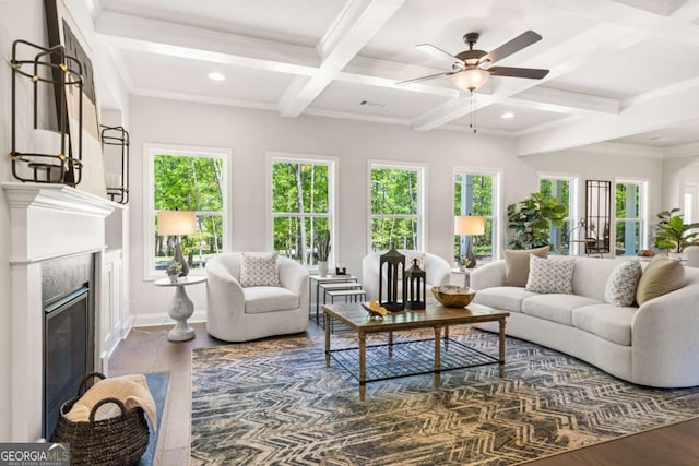 living area with beamed ceiling, coffered ceiling, dark wood finished floors, and a high end fireplace