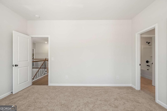 unfurnished bedroom featuring carpet floors and baseboards