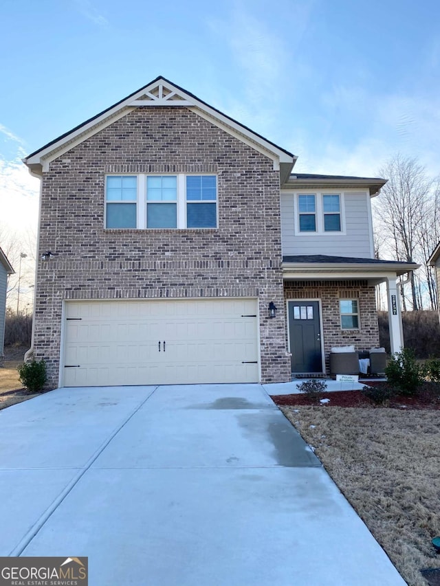 view of front of home featuring a garage, driveway, a porch, and brick siding