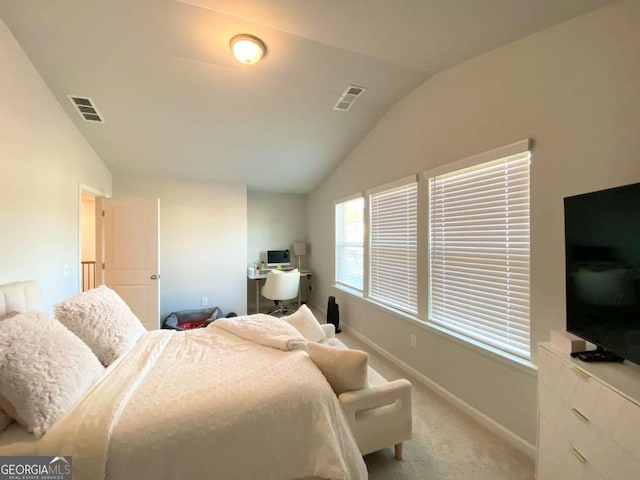 bedroom with lofted ceiling, visible vents, light carpet, and baseboards