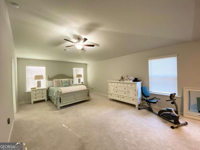 bedroom featuring visible vents, ceiling fan, light carpet, and baseboards