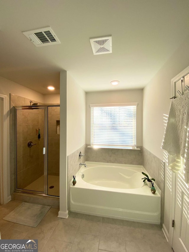 bathroom with visible vents, a garden tub, a shower stall, and tile patterned floors