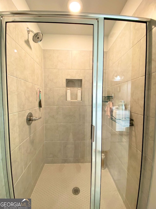 bathroom featuring a shower stall