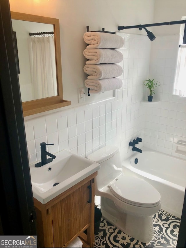 bathroom with tile walls, toilet, shower / tub combo, vanity, and tile patterned flooring