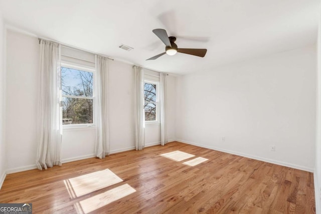 unfurnished bedroom with visible vents, ceiling fan, baseboards, and wood finished floors