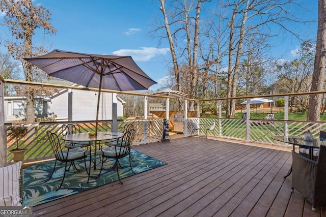 wooden terrace featuring outdoor dining space