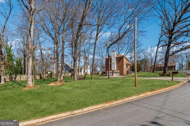 view of yard with a garage and fence