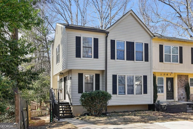 view of front of property featuring fence