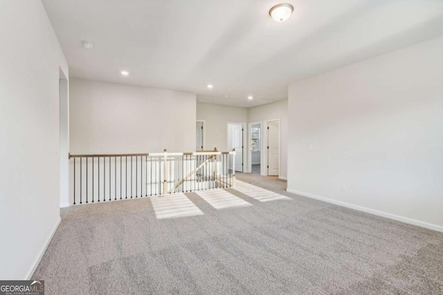 empty room with recessed lighting, carpet, and baseboards