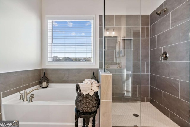 bathroom featuring a garden tub and a tile shower