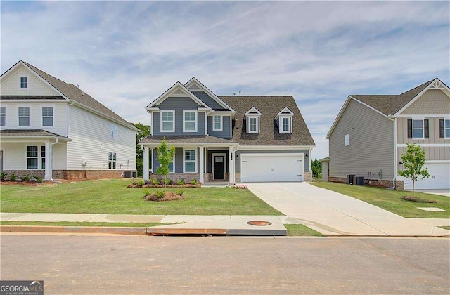 craftsman house with a garage, concrete driveway, and a front lawn